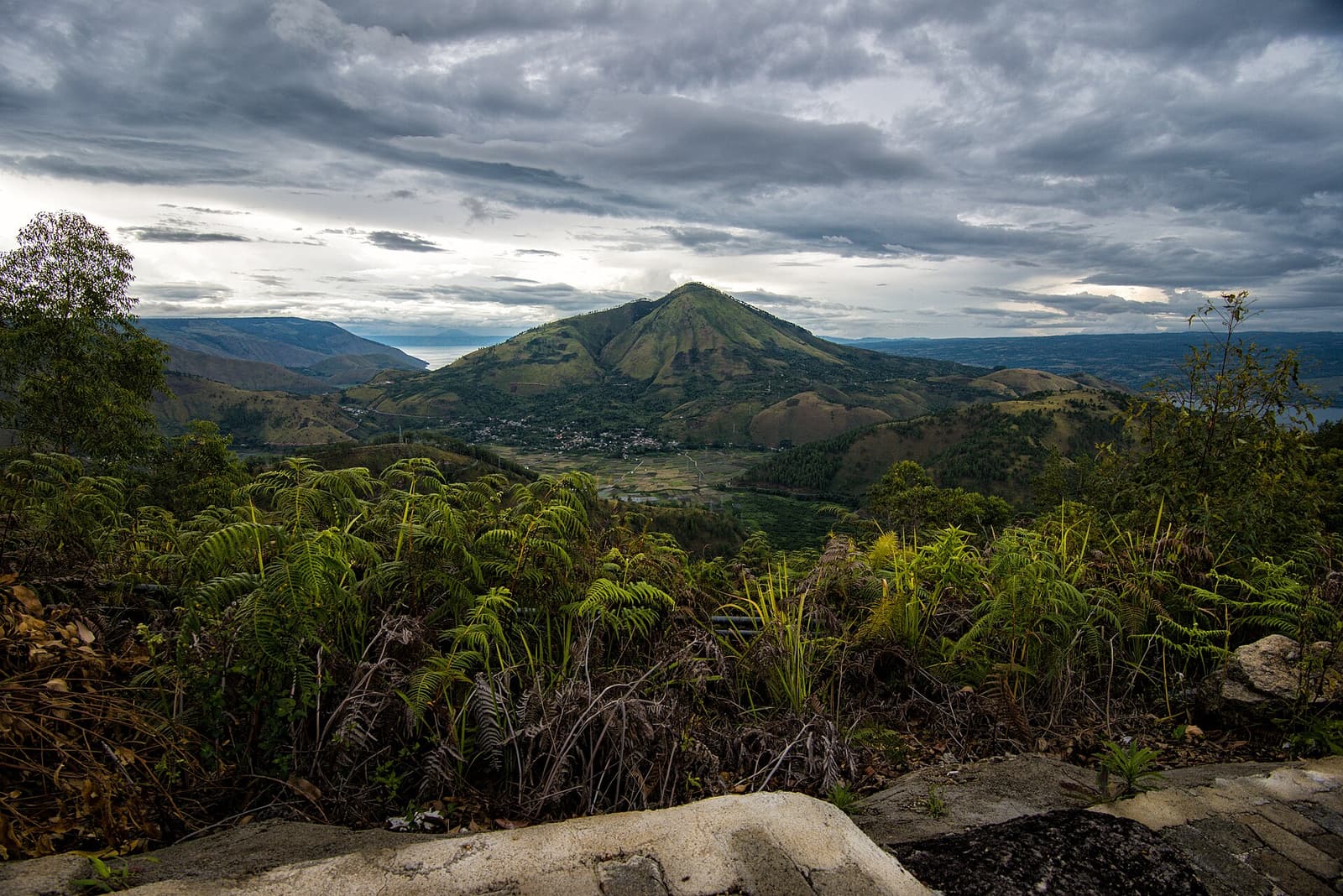 The cone of Pusuk Buhit rising above Lake Toba, seen from the road to Tele