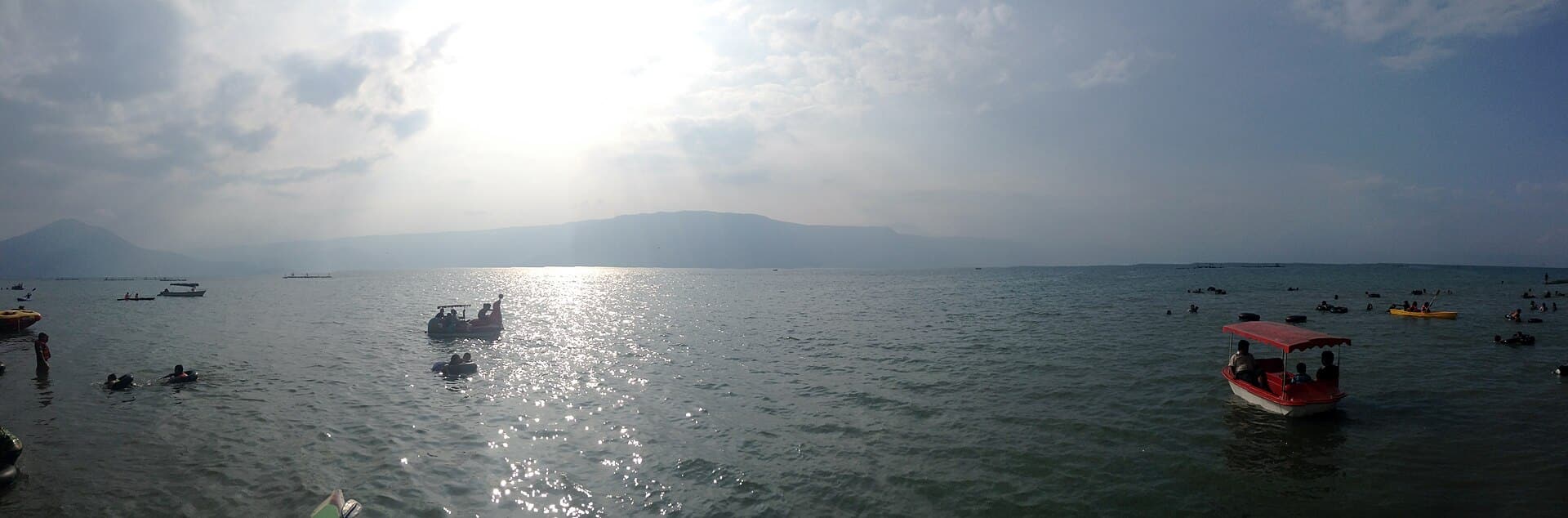 Small boats on Lake Toba in the afternoon sun