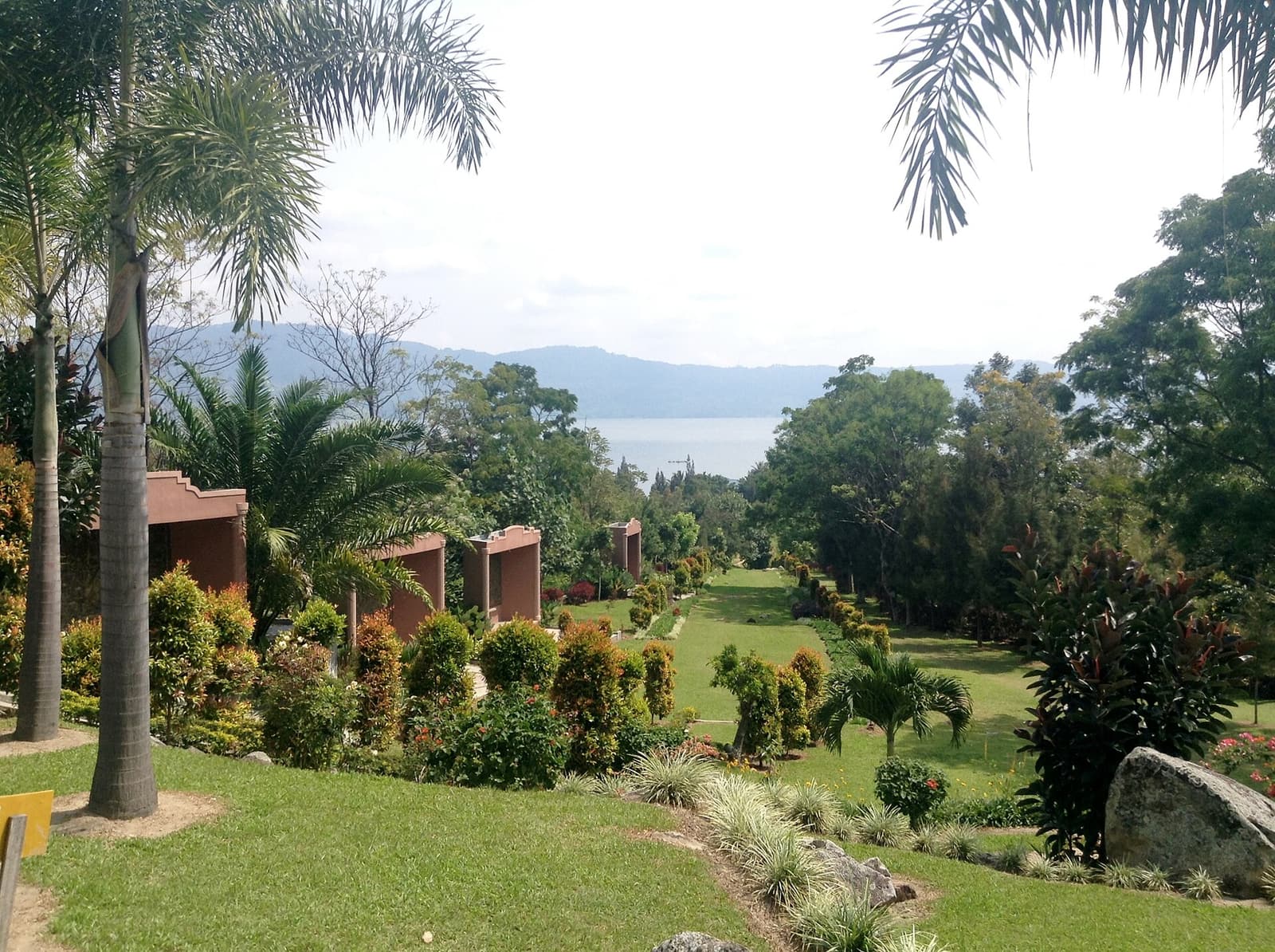 A hotel garden overlooking Lake Toba